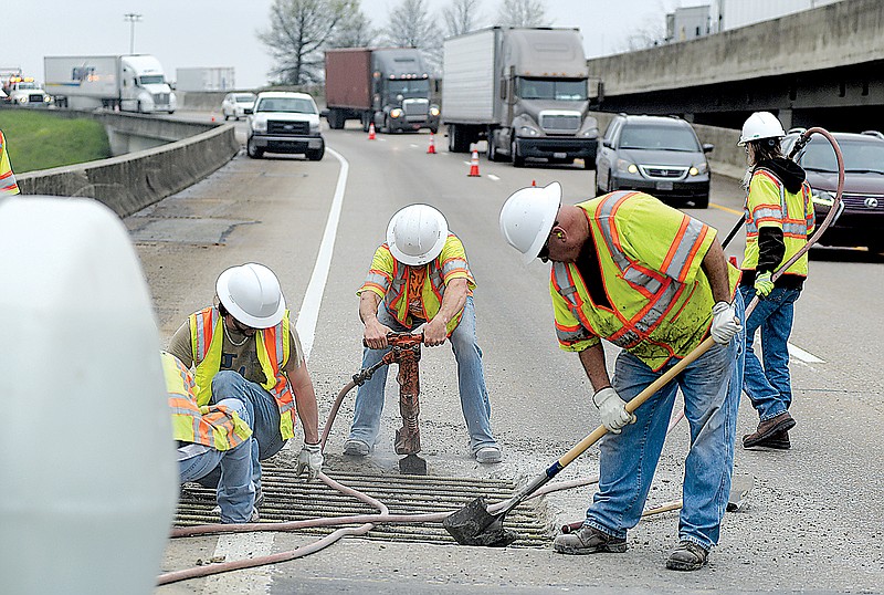 TDOT workers repair the road surface on eastbound Interstate 24 at the overpass above Chestnut Street in this April 2015, file photo.