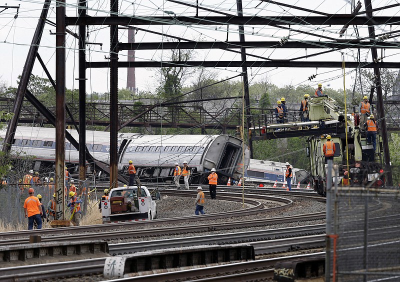 Emergency personnel walk near the scene of a deadly train wreck, Wednesday, May 13, 2015, in Philadelphia. 