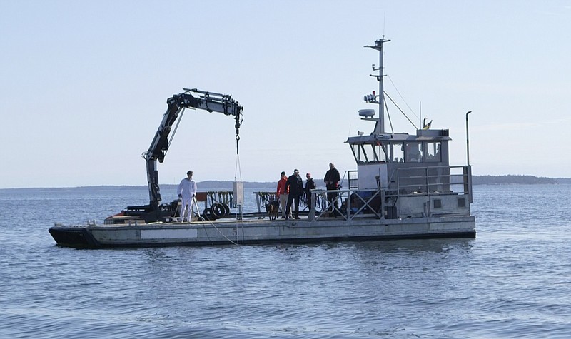 
              In this photo taken on April 27, 2015 and made available by Swedish Peace and Arbitration Society on Wednesday May 13, 2015, an underwater defense device is lowered into the water in the archipelago, outside Stockholm, Sweden. Swedish peace activists who argue that military hardware isn't the best way to deter Russian submarines have launched their own underwater defense installation: a gay-themed sonar system. (Swedish Peace and Arbitration Society via AP)
            