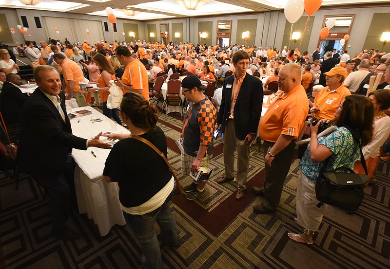 University of Tennessee basketball coach Rick Barnes, far left, greets Volunteer fan Samantha Lewelling as hundreds gather for the Big Orange Caravan at The Chattanoogan hotel on Wednesday, May 13, 2015.