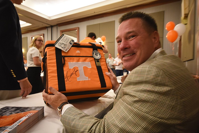 Butch Jones smiles after signing a Tennessee Vols cooler Wednesday during the Big Orange Caravan event at The Chattanoogan on Wednesday, May 13, 2015.