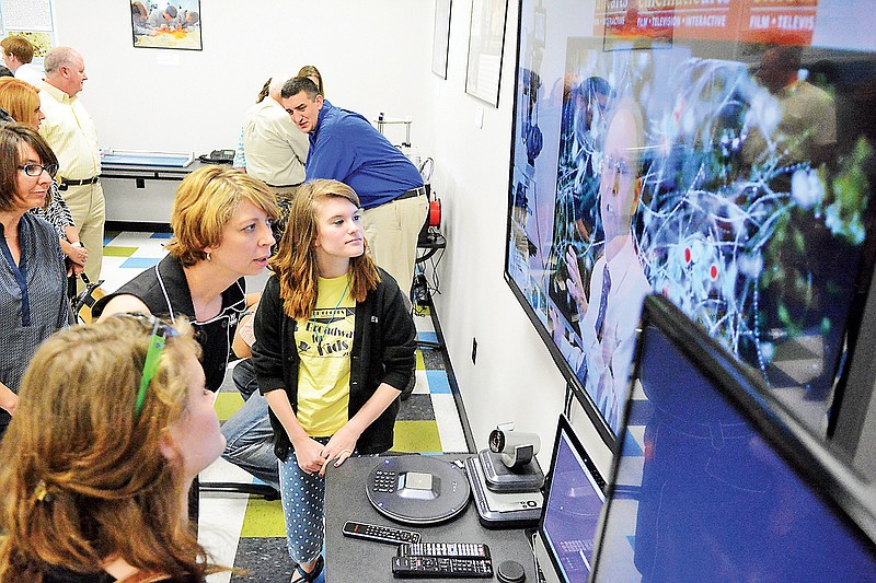 Christa Payne of the Public Education Foundation, center, joins STEM School students Sarah Goldsmith, left, and Alexis Goldsmith as they chat with Richard Weinberg, a research associate professor at the University of California School of Cinematic Arts, on Thursday, May 14, 2015.