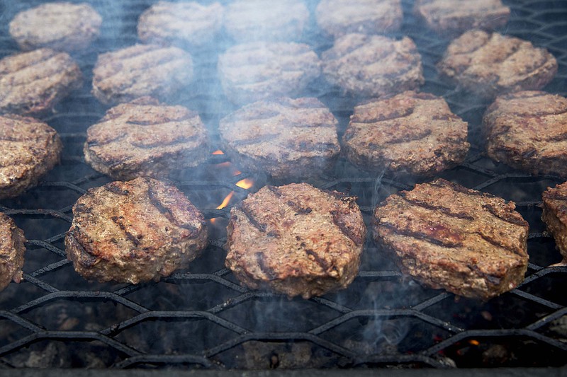 
              FILE - In this Thursday, July 3, 2014 file photo, smoke wafts up as hamburgers are cooked on a grill outside the White House in Washington. On Thursday, May 14, 2015, the CDC says fewer Americans are getting sick from a nasty germ sometimes found in undercooked hamburgers. Illnesses from a dangerous form of E. coli bacteria have fallen 20 percent in the previous few years. (AP Photo/Jacquelyn Martin)
            