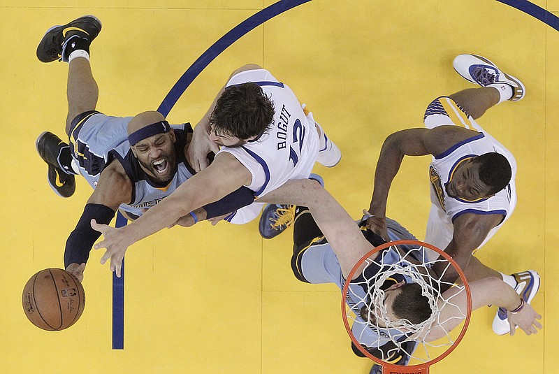 Memphis Grizzlies guard Vince Carter, left, shoots against Golden State Warriors center Andrew Bogut during the first half of Game 5 in a second-round NBA playoff basketball series in Oakland, Calif., Wednesday, May 13, 2015. The Warriors won 98-78.