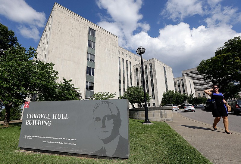 In this July 2, 2013, file photo, a woman walks past the Cordell Hull Building in Nashville.