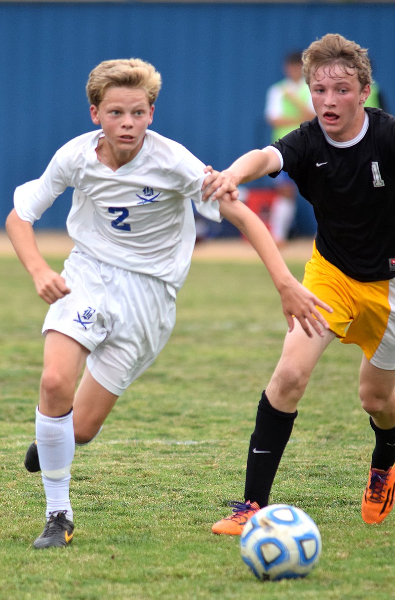 Boyd Buchanan's Hayes Wood (2) advances upfield while Hixson's Spencer Graves (1) defends. The Hixson Wildcats visited the Boyd-Buchanan Buccaneers in the championship match of Region 3-A/AA soccer Thursday, May 14, 2015.