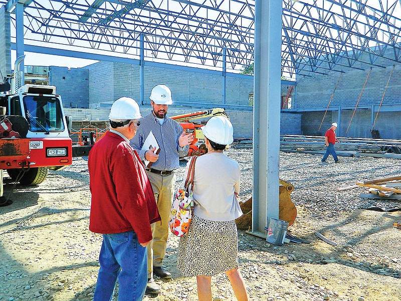 Architectural consultant Brian Templeton of Upland Design, center, speaks with Cleveland school board members George Meacham, left, and Peggy Pesterfield during a tour of the Raider Arena construction site at Cleveland High School. Raider Arena, projected to be completed in February 2016, will replace the school's landmark Raider Dome, which was demolished last summer.