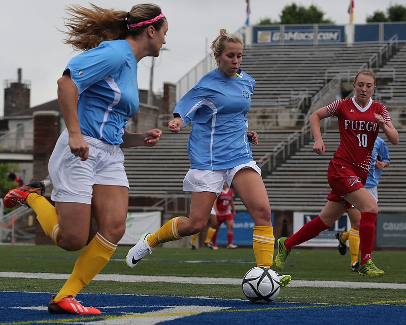 Chattanooga's Brittney Reed and Kelly Downs dribble the ball down field past Mississippi's Jade Pennock at Finley Stadium during their game o May 18, 2014, in Chattanooga.