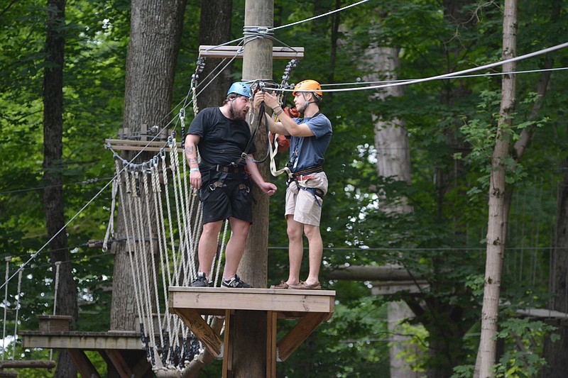 Billy Johnson, left, gets instruction from Aaron Randall before riding suspended from a cable at the ZIPstream Aerial Adventure at Ruby Falls on May 10, 2015, in Chattanooga.