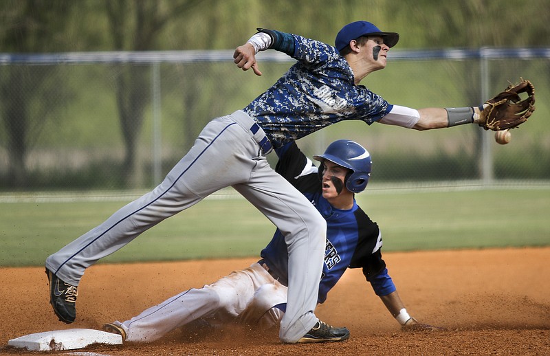 Boyd-Buchanan runner Cade Evans slides into 3rd to beat a wild throw to Jackson County 3rd baseman Tyler Boling during the Buccaneers' state sectional baseball game against Jackson County on Friday, May 15, 2015, at Boyd-Buchanan School in Chattanooga.