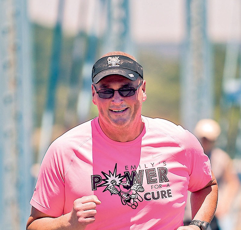 Robert Starnes runs across the Walnut Street Bridge in training for the event. 