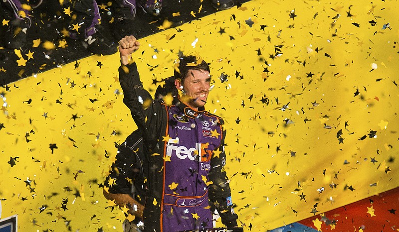 Denny Hamlin celebrates in Victory Lane after winning the NASCAR Sprint All-Star auto race at Charlotte Motor Speedway in Concord, N.C., on Saturday, May 16, 2015.