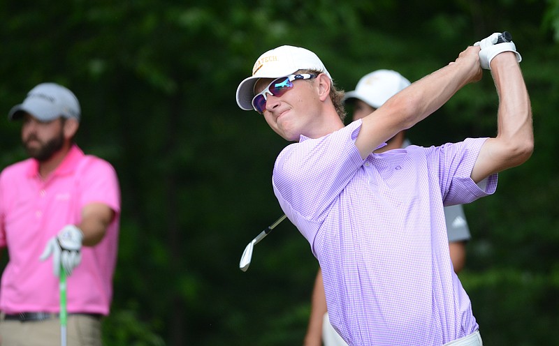 Drew Czuchry hits a tee shot at the Signal Mountain Golf and Country Club on Sunday, May 17, 2015. Watching at left is Taylor Lewis.