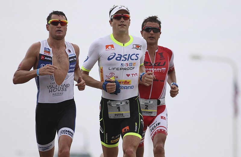 Professional triathletes Leon Griffin #4, Andy Potts #1 and Bozzone Terenzo #2 crest the Veteran's Bridge while running the first lap of the run course during the inaugural Sunbelt Bakery Ironman 70.3 Chattanooga race on Sunday, May 17, 2015. U.S. athlete Andy Potts won the race with a final time of 3:49:43.