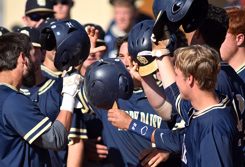 The Soddy-Daisy Trojans celebrate a three-run home run by Dillon Clift, far left, early in their game against the Hurricanes on May 13, 2015.