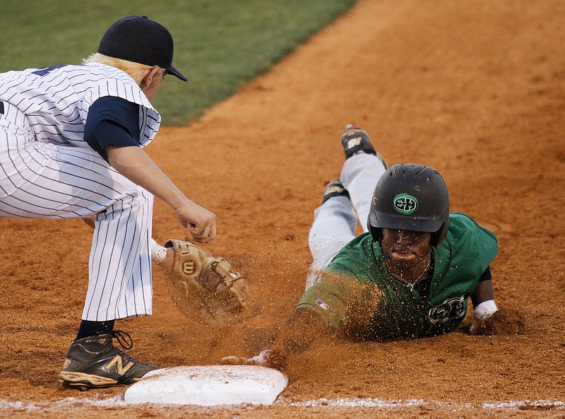 East Hamilton runner Jeffrey Coleman beats the pickoff throw and tag by Farragut 1st baseman Jake Hagenow during their Class AAA state baseball tournament game Tuesday, May 19, 2015, at the TSSAA Spring Fling in Murfreesboro, Tenn.