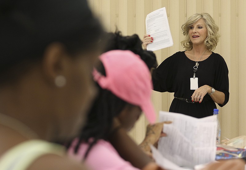Theresa Biggs speaks to applicants during the first wave of Section 8 interviews at the Chattanooga Housing Authority last week.