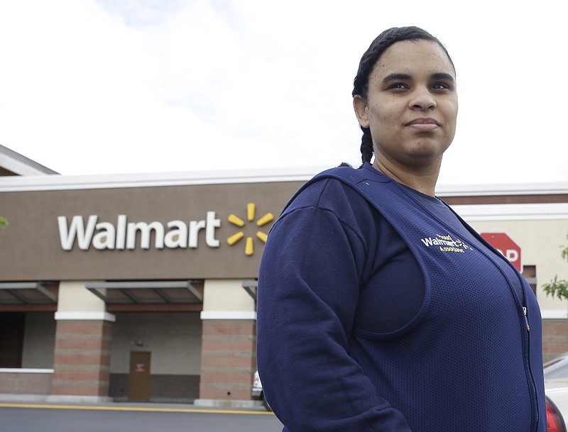 
              In this Friday, May 15, 2015 photo, Shannon Henderson poses outside the Wal-Mart store where she works as a part-time customer service representative, in Sacramento, Calif. Henderson is one of an estimated 40 million American workers for who calling in sick is a luxury. If they don’t work, they don’t get paid. (AP Photo/Rich Pedroncelli)
            