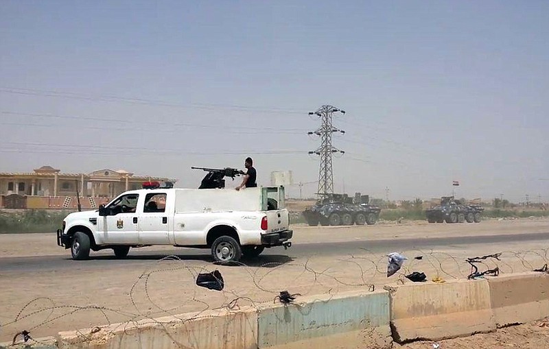 
              Arriving from Baghdad, federal police forces create a barricade to protect the Habaniyah military base near Ramadi, Iraq, in eastern Husaybah town, 8 kilometers (5 miles) east of Ramadi on Monday, May 18, 2015. Islamic State group militants likely killed up to 500 Iraqi civilians and soldiers and forced 8,000 people to flee from their homes as they captured Ramadi, a provincial official said Monday, while the extremists went door-to-door looking for policemen and pro-government tribesmen. (AP Photo)
            