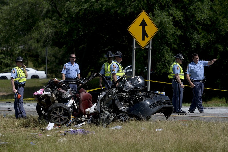 Multiple police officers investigate a car involved in a multiple car accident on I-16 in Pooler, Ga., on Tuesday, May 19, 2015. 
