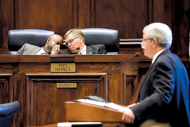 Commissioners Warren Mackey, left, and Marty Haynes confer as Hamilton County Schools Superintendent Rick Smith speaks to the Hamilton County Commission.