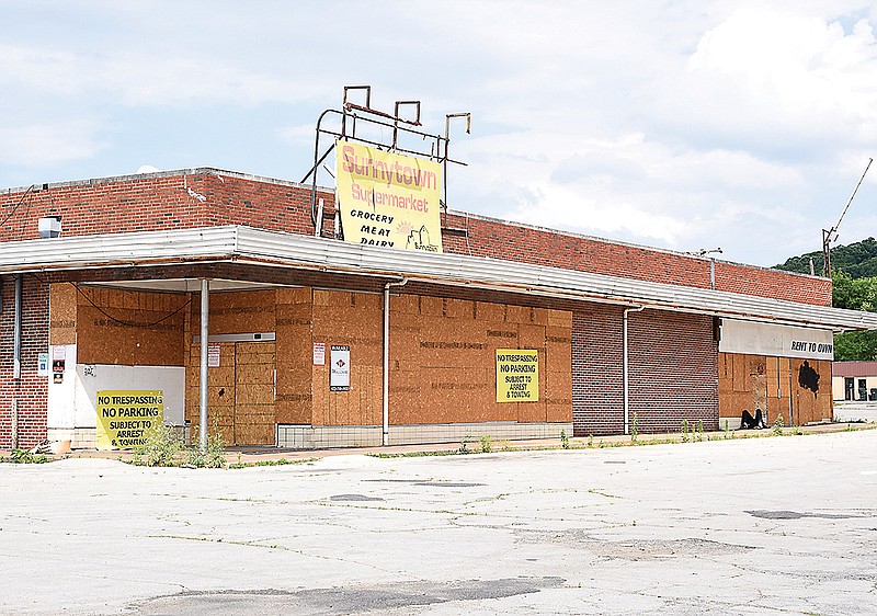 The old Sunny Town Grocery property on Dodson Avenue has been purchased by the owners of Rogers Market on Main Street.