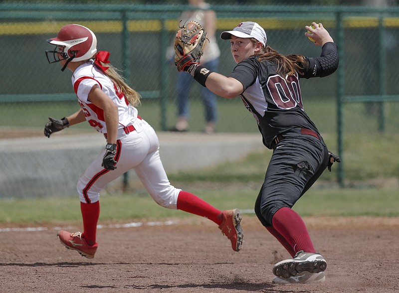 Ooltewah runner Jadyn Raschke runs past Bearden shortstop Alaeni Ray as she makes the throw to first during their Class AAA state softball tournament at the TSSAA Spring Fling in Murfreesboro, Tenn., on Wednesday, May 20, 2015. Ooltewah won 5-0.