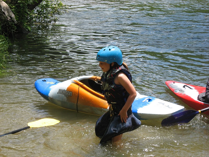 Tennessee Valley Canoe Club paddle school student Kate Berube makes her way to shore after making a "wet exit" from her kayak on the Hiwassee River. 