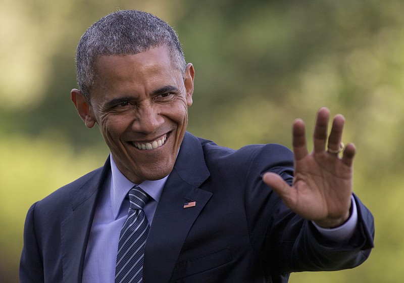 President Barack Obama waves as he walks across the South Lawn to the White House from Marine One, Wednesday, May 20, 2015, in Washington, as he returns from Connecticut where he delivered the commencement address at the United States Coast Guard Academy and attended a Democratic National Committee event.