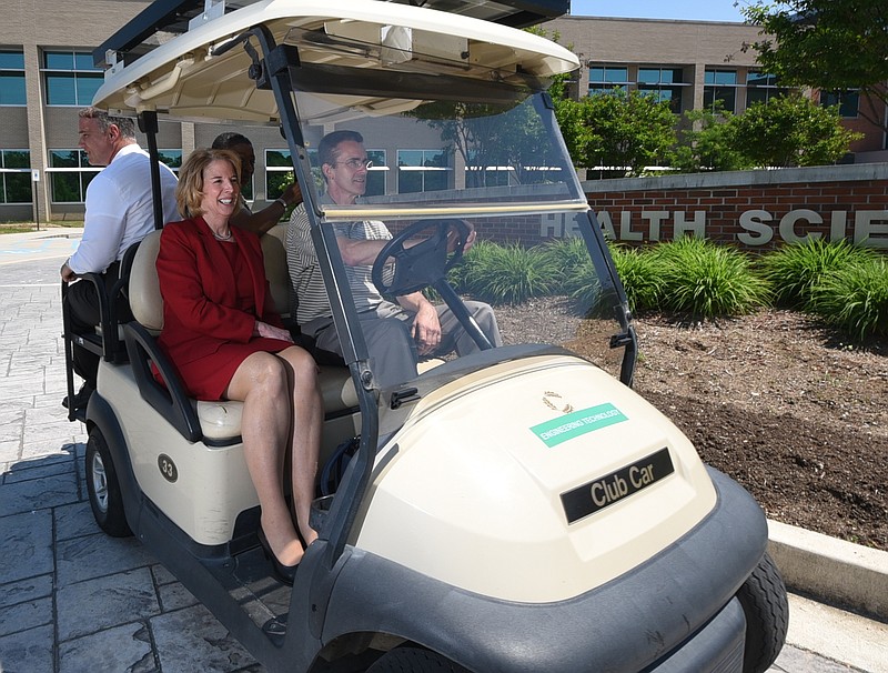 Dr. Flora Tydings, President of Athens Technical College in Georgia, rides in a golf cart to tour the Chattanooga State campus Wednesday as a candidate for the school's president. 