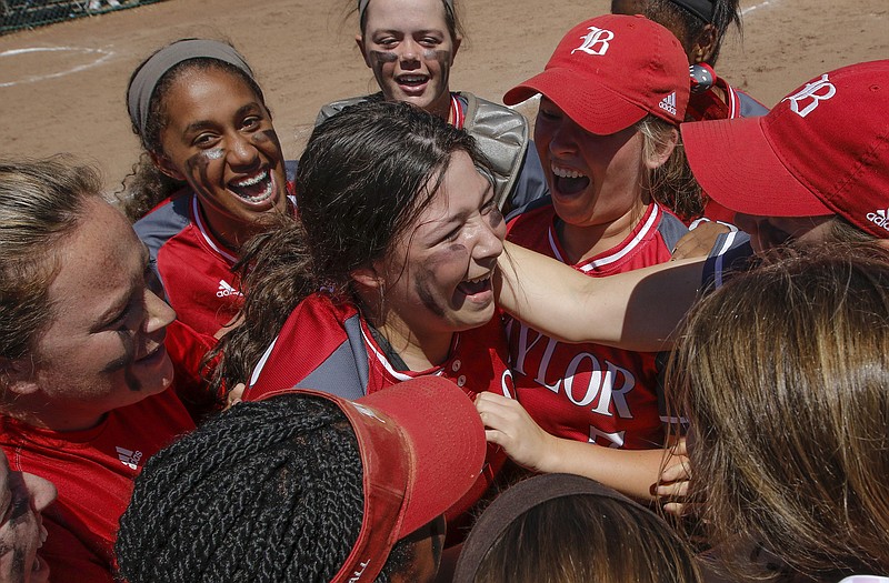 Baylor players celebrate in the pitcher's circle with pitcher Kayla Hughes, center, after their 6-4 win over GPS in their D-II AA state softball tournament championship game Thursday, May 21, 2015, at the TSSAA Spring Fling in Murfreesboro, Tenn.