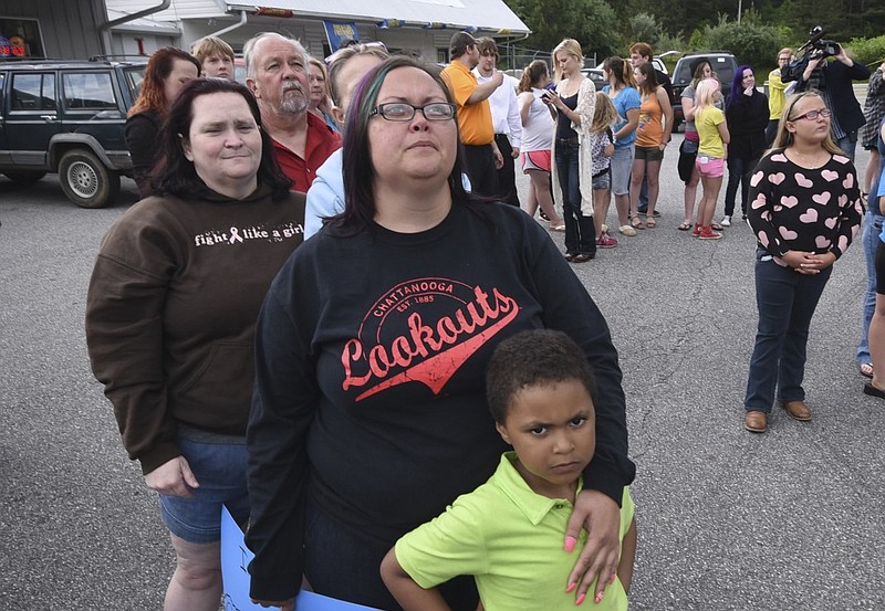 Angel Harris, center, and her son, Darrius, 5, watch balloons sail away Thursday at the memorial release in Copperhill, Tenn.
Nearly 100 people came to the afternoon release to see black and blue colored balloons float away in remembrance of two deceased Copper Basin students that were victims of bullying in Polk County.  
Friend, Erica Cavender, left, and Angel's father, Haril Harris, second from left, focused on the sky.
