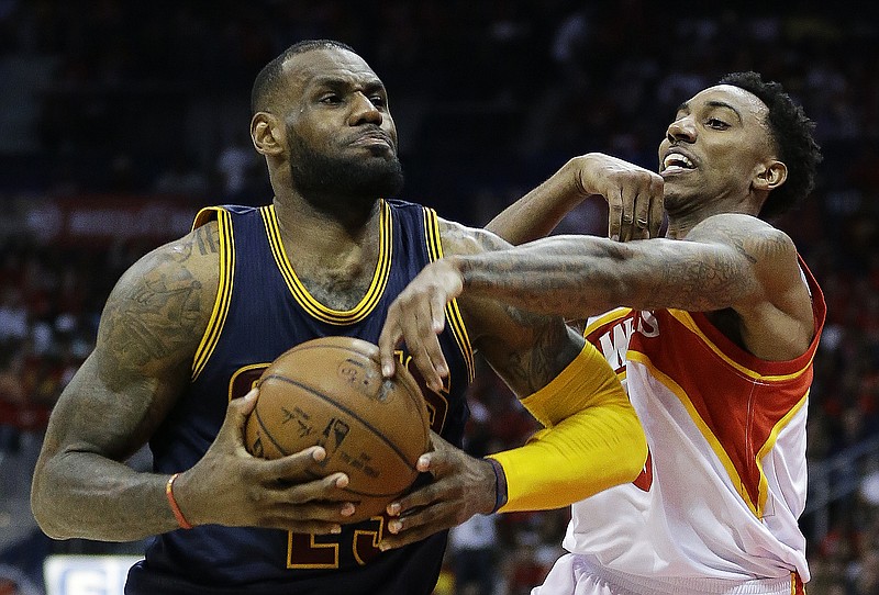 
              Cleveland Cavaliers forward LeBron James (23) is fouled by Atlanta Hawks guard Jeff Teague (0) during the second half in Game 2 of the Eastern Conference finals of the NBA basketball playoffs, Friday, May 22, 2015, in Atlanta. (AP Photo/David Goldman)
            