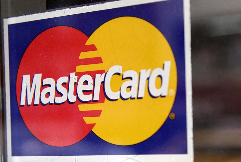 This January, 2015, file photo shows a window decal indicating that MasterCard is accepted at a New York business. 