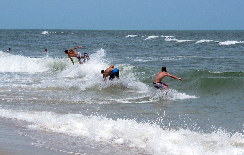 
              This June 30, 2014 photo,  surfers ride waves in Ship Bottom, N.J. on Long Beach Island. Two New Jersey lawmakers on Friday May 22, 2015 called on Rutgers University to cancel planned ocean blasting tests off Long Beach island that they say will harm marine life and threaten new Jersey's crucial tourism industry. (AP Photo/Wayne Parry)
            
