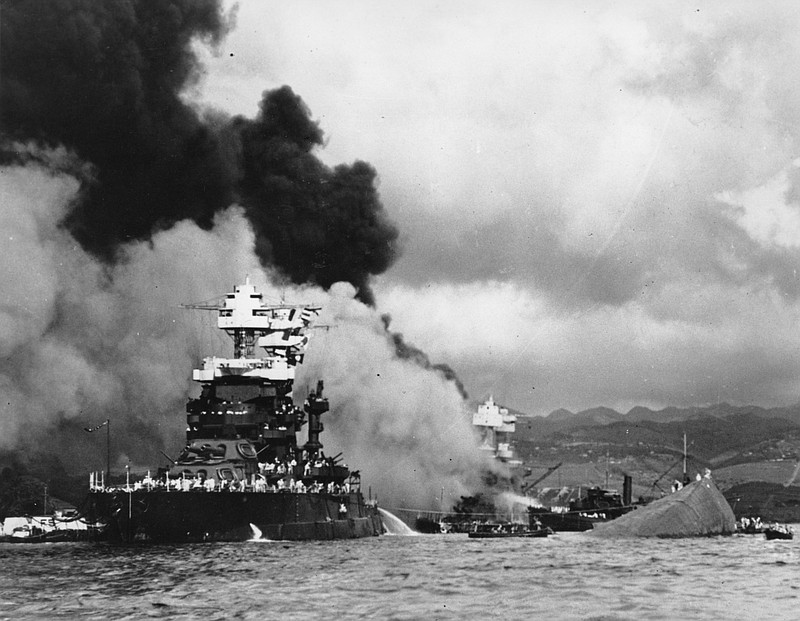 
              ADVANCE FOR USE SATURDAY, MAY 23, 2014 AND THEREAFTER - FILE - In this Dec. 7, 1941 file photo, part of the hull of the capsized USS Oklahoma is seen at right as the battleship USS West Virginia, center, begins to sink after suffering heavy damage, while the USS Maryland, left, is still afloat in Pearl Harbor, Oahu, Hawaii. (AP Photo/U.S. Navy, File)
            