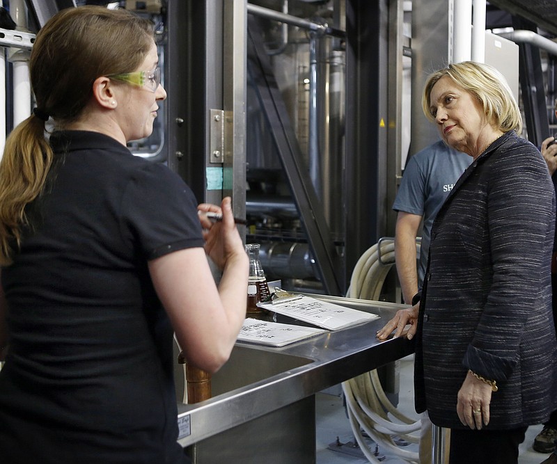 
              Democratic presidential candidate Hillary Rodham Clinton talks with Lee Lord during a tour of the Smuttynose Brewery, Friday, May 22, 2015, in Hampton, N.H. (AP Photo/Jim Cole)
            