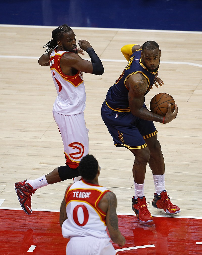 Cleveland Cavaliers forward LeBron James (23) moves the ball against Atlanta Hawks forward DeMarre Carroll (5) during their Game 2 of the Eastern Conference finals of the NBA basketball playoffs on Friday, May 22, 2015, in Atlanta. The Cleveland Cavaliers won 94-82. 