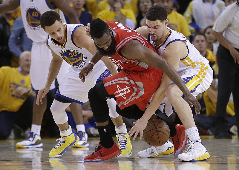 
Houston Rockets guard James Harden, center, loses the ball on the game's final play as he Golden State Warriors guards Stephen Curry, left, and Klay Thompson defend during the second half of Game 2 of the NBA basketball Western Conference finals in Oakland, Calif., Thursday, May 21, 2015. The Warriors won 99-98. 