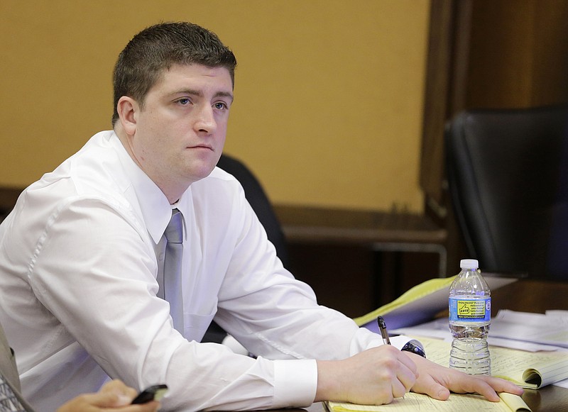 
              FILE - In this April 9, 2015, file photo, Cleveland police Officer Michael Brelo listens to testimony during his trial in Cleveland.  A judge has reached a verdict in the trial of Brelo charged with voluntary manslaughter in the shooting deaths of two unarmed people in a 137-shot barrage of police gunfire. Saturday, May 23, 2015 verdict comes after four weeks of testimony in Brelo's  trial in the deaths of Timothy Russell and Malissa Wiliiams in November 2012.  (AP Photo/Tony Dejak, Pool, File)
            