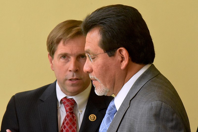 Former U. S. Attorney General Alberto Gonzales talks with U. S. Congressman Chuck Fleischmann, left, before speaking at the Brainerd Kiwanis Club meeting at the Chattanooga Choo Choo on April 21, 2015, in Chattanooga.