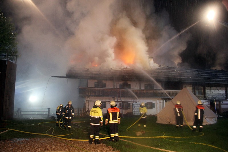 
              Firefighters try to extinguish a fire  in the Bavarian town of Schneizlreuth , Germany, early Saturday May 23, 2015. Police in Germany say six people are missing after a fire at a guesthouse in Bavaria. In a statement Saturday, police said the fire broke out overnight in a converted farmhouse in the town of Schneizlreuth, southeast of Munich near the border with Austria. Of the 47 people staying at the guesthouse, 41 were able to flee.   ( Ferdinand Farthofer/aktivnews/dpa  via AP)
            