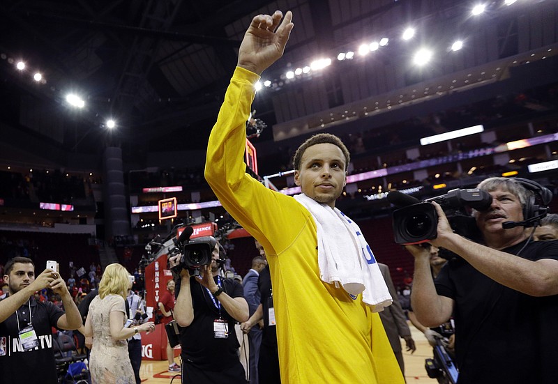 Golden State Warriors guard Stephen Curry gestures after Game 3 of the NBA basketball Western Conference finals against the Houston Rockets on Saturday, May 23, 2015, in Houston. The Warriors won 115-80. 