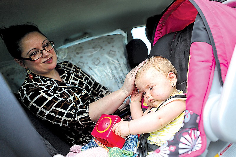 Ginger Land picks up her granddaughter, Tobi McBryar, to take the baby to her home.