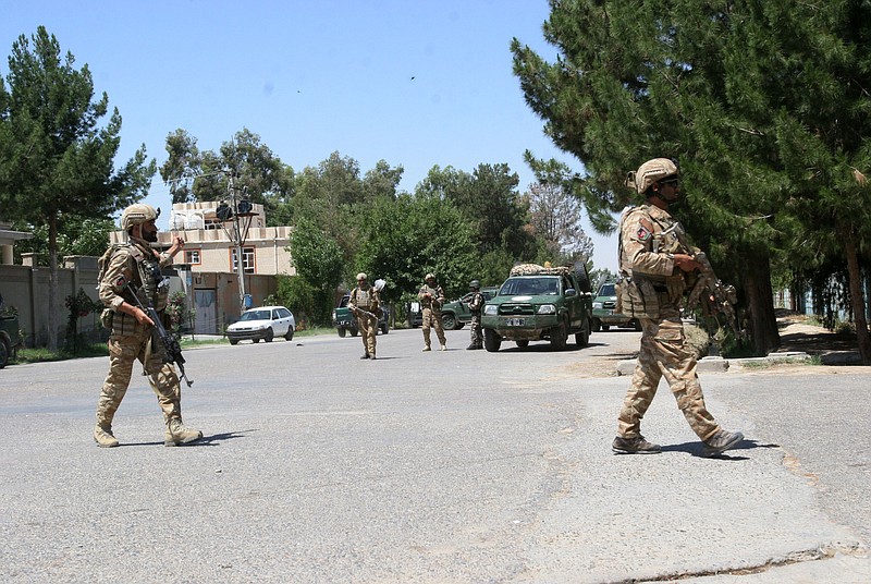 Afghanistan, security forces take position during a fighting outside a government compound in the city of Lashkar Gah, capital of Helmand province, Afghanistan,in this May. 13, 2015, file photo. Officials say gunmen have attacked a government compound in southern Afghanistan, killing three police and four civilians. 