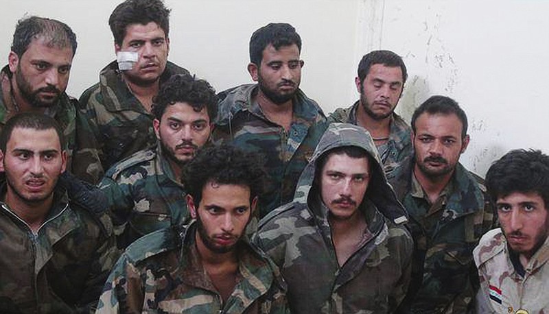 
              This picture released on Sunday, May 24, 2015, by a militant website which had been verified and is consistent with other AP reporting shows Syrian government soldiers who were captured by Islamic state militants in Palmyra area in Syria. The Syrian army is deploying troops in areas near the ancient town of Palmyra in apparent preparation for a counterattack to retake it from the Islamic State group, an official said. (Militant website via AP)
            