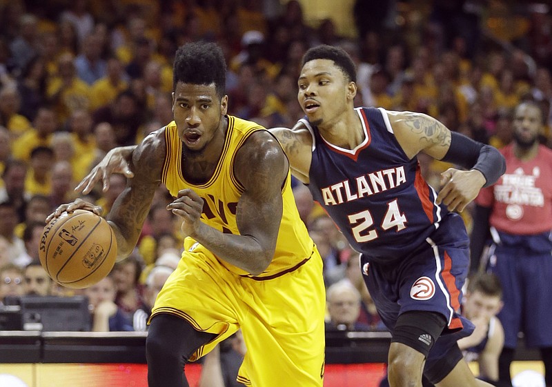 Atlanta Hawks' Kent Bazemore (24) tries to knock the ball away from Cleveland Cavaliers' Iman Shumpert during their Game 3 of the Eastern Conference finals of the NBA basketball playoffs Sunday, May 24, 2015, in Cleveland.
