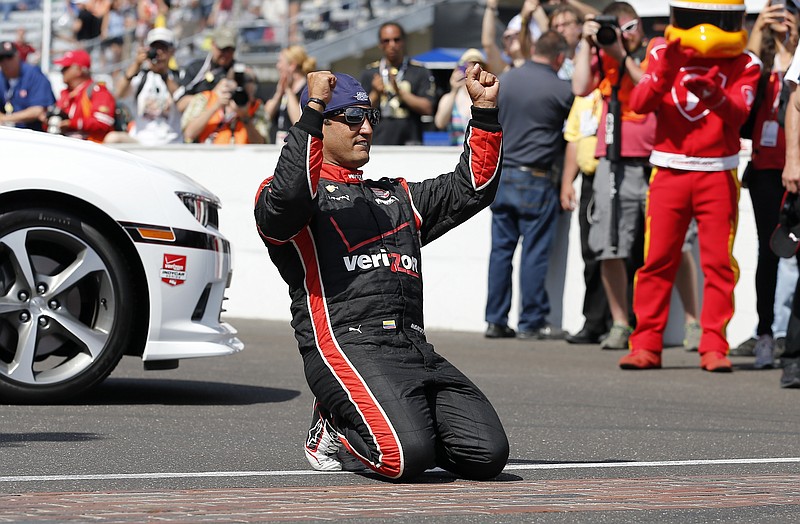 Juan Pablo Montoya, of Colombia, celebrates after winning the 99th running of the Indianapolis 500 race at Indianapolis Motor Speedway in Indianapolis on Sunday, May 24, 2015.