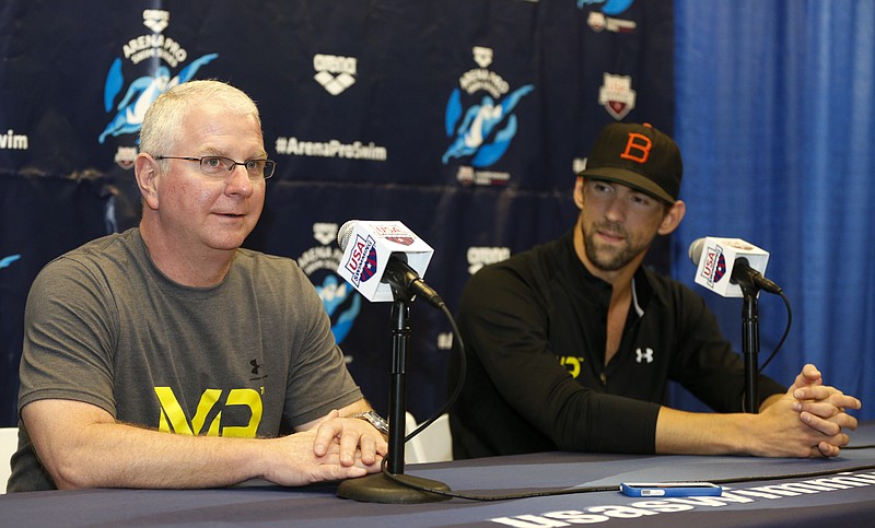 
              FILE - In this May 14, 2015, file photo, Bob Bowman, left, answers a question as Michael Phelps looks on at a press conference at the Arena Pro Swim Series swim meet in Charlotte, N.C. Bowman will always be known as Michael Phelps’ coach. But Phelps won’t be around forever, so Bowman started thinking about his own future. It led him back to the college ranks and a new job at Arizona State. (AP Photo/Nell Redmond, File)
            
