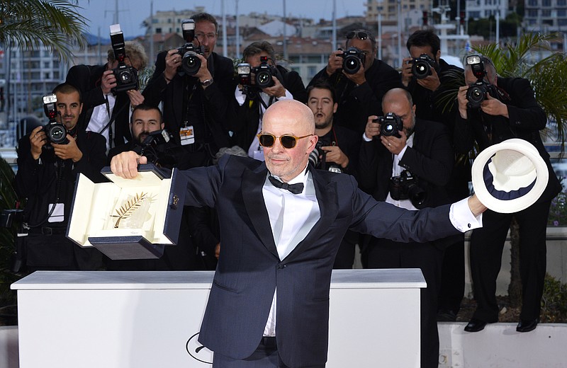 
              Director Jacques Audiard holds the Palme d’Or award for the film Dheepan as he poses for photographers during a photo call following the awards ceremony at the 68th international film festival, Cannes, southern France, Sunday, May 24, 2015. (AP Photo)
            